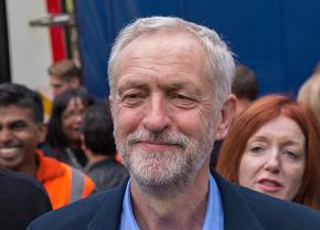 Jeremy Corbyn arrives at a refugee rights rally after his victory in the Labour Party leadership vote